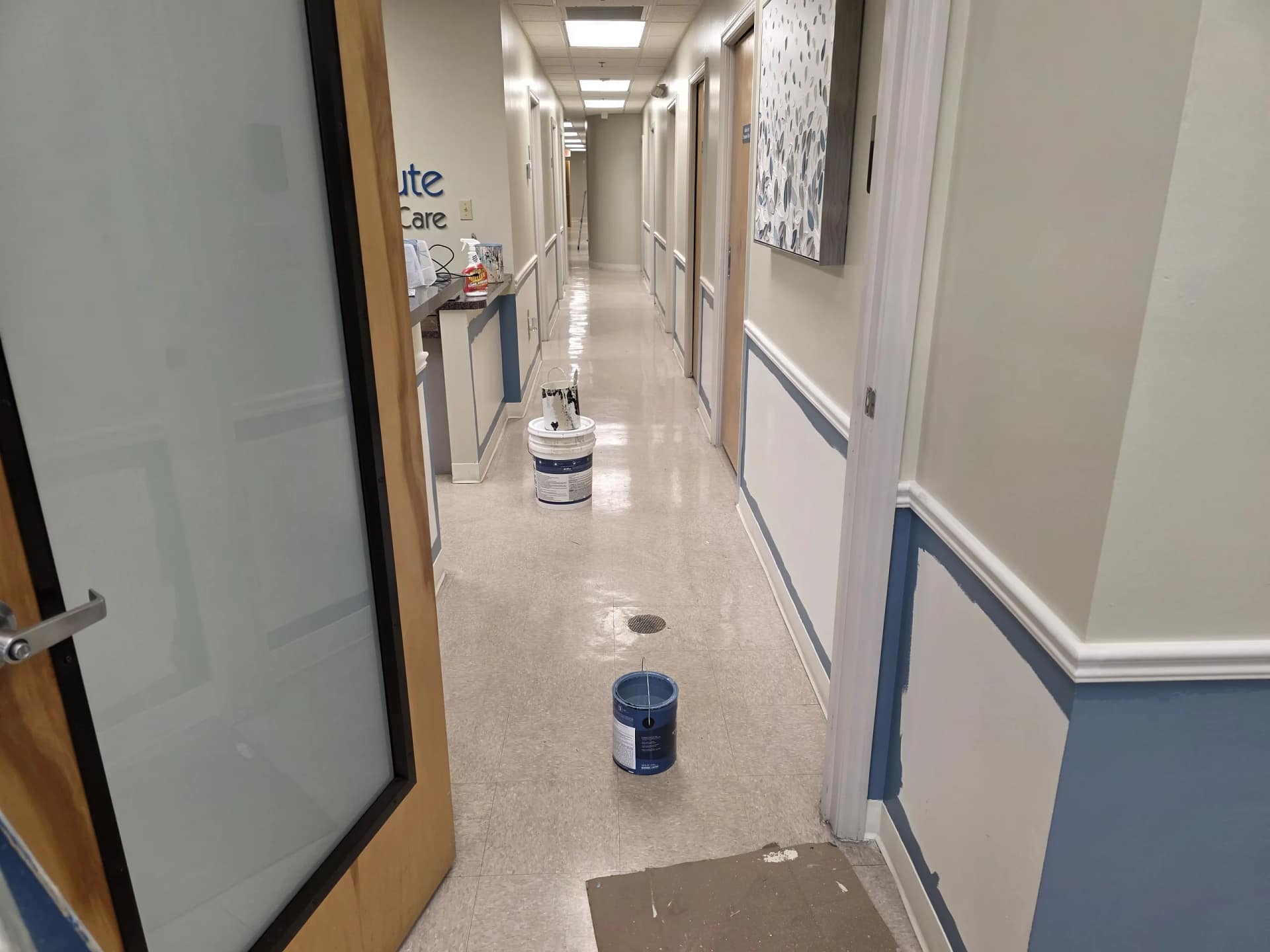 Commercial hallway being painted while ventilation and access are managed